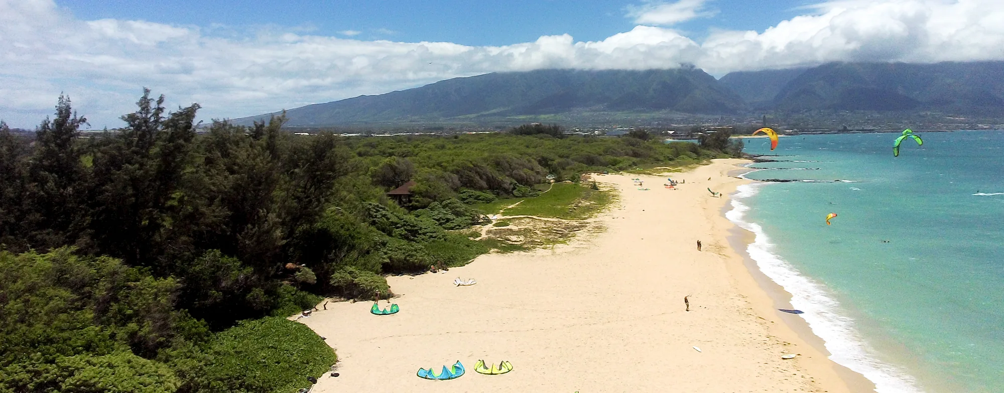 A sweeping view of Kanaha Beach with the West Maui Mountains beyond